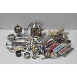 A collection of silver plated wares, including: casters, a biscuit barrel and cover, tongs, cutlery,