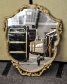 A shield shaped mirror with a gilt frame by Atsonea,