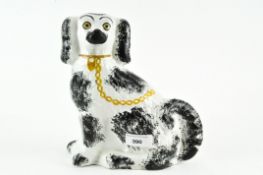 A Staffordshire figure of a dog, with sponged decoration,