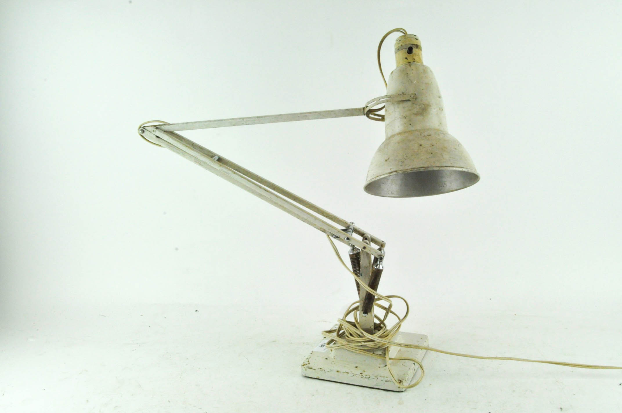 A white painted metal anglepoise lamp on square footed base,