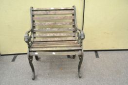 A small garden chair with cast metal ends,