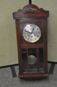 A mahogany cased wall clock, with pendulum,
