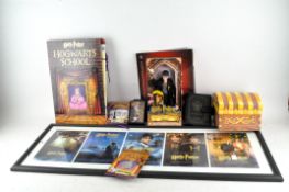A collection of Harry Potter ephemera, including a Gringotts saving book, a figure of Harry Potter,