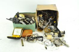 A large collection of watches and travel clocks including spare parts, movements,
