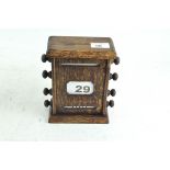 An oak perpetual calendar, 19cm high, 16cm wide,