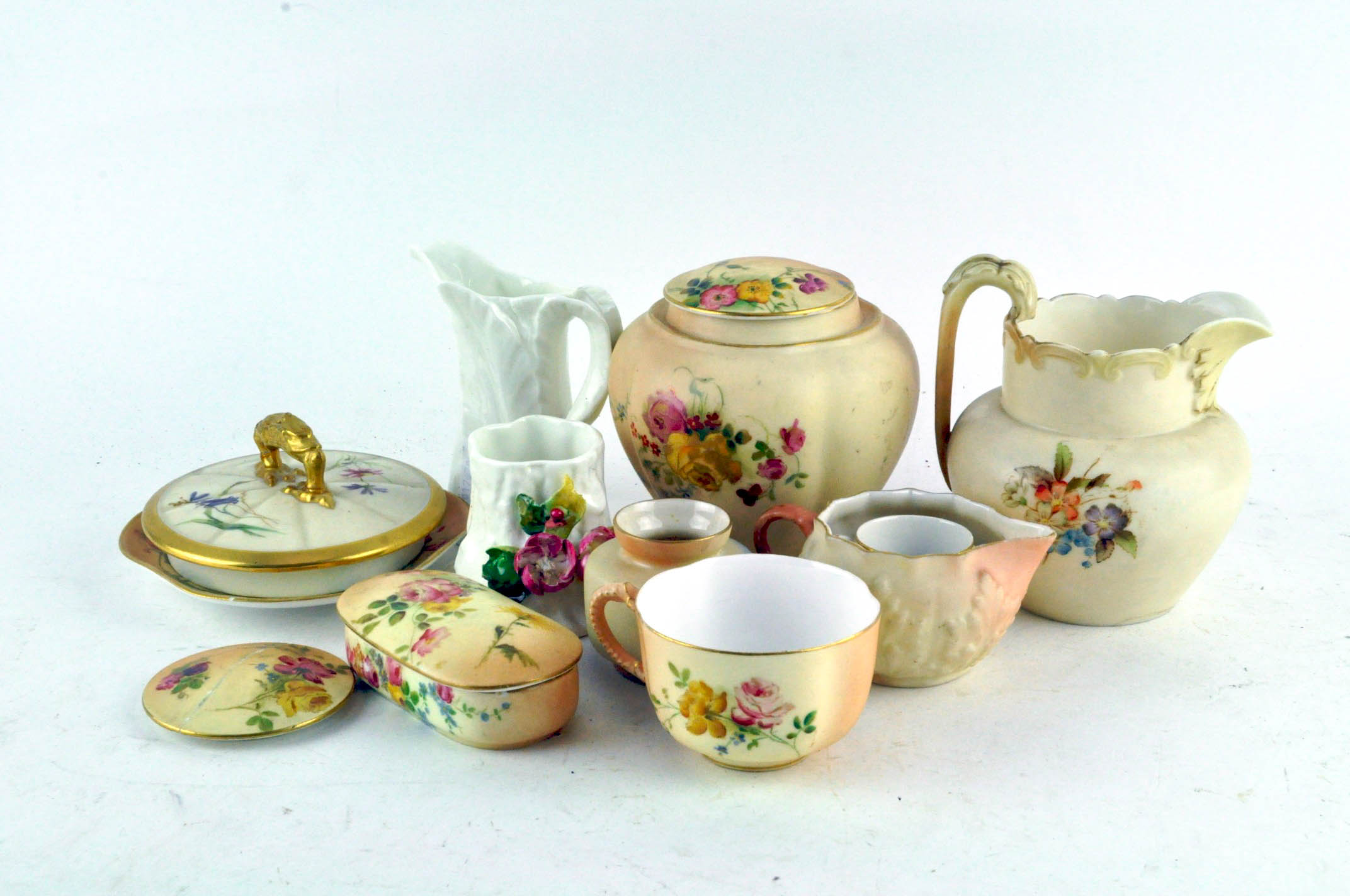 A collection of Royal Worcester porcelain, predominately blush ivory ground and flowers,