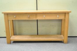 A modern oak hall table with two drawers,