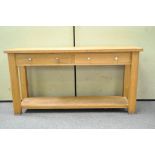 A modern oak hall table with two drawers,
