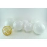 A collection of six milk glass globe shape light shades and another in pale gold (7)