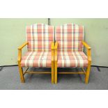 A pair of upholstered armchairs with similar footstool and another