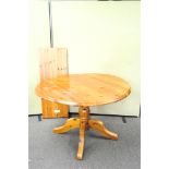 A pine circular extending dining table,