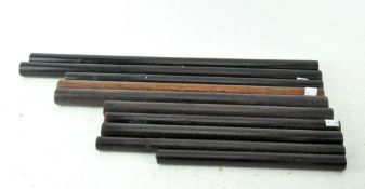 A collection of wooden measuring sticks, including Lignum Vitae examples,