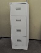 A four drawer filing cabinet, 130 cm x 47 cm wide x 62.5 cm.