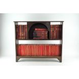 A miniature bookshelf containing a collection of leather bound and cloth bound books,