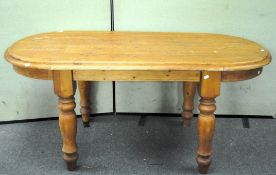 A pine dining table of oval form,
