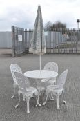 A Victorian style cast metal patio table and four chairs,