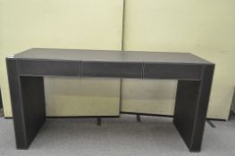 A large faux leather three drawer sideboard,