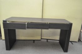 A large faux leather three drawer sideboard,
