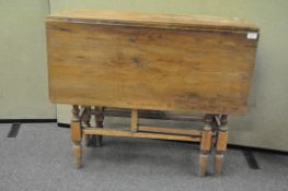 A pine drop leaf dining table,