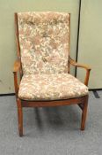 A Parker Knoll armchair, with button upholstery,