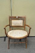 An Edwardian walnut and inlaid armchair,