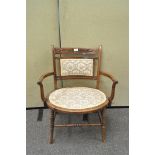 An Edwardian walnut and inlaid armchair,