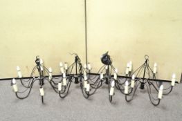 A set of four six light chandeliers,