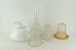 Four frosted and milk glass oil lamp shades and a frosted flue,