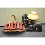 An assortment of collectables, including a tribal mask, wicker picnic basket,