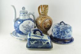 A collection of blue and white ceramics including a cheese bell and stand, hot plate,