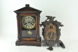 A mahogany cased mantel clock with a temple pediment,