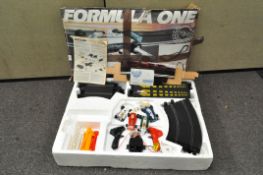 A Scalextrix Formula 1 set in original box, including four cars,