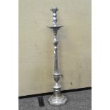 A large chrome floor standing candlestick