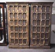 A pair of carved wooden wardrobes, probably Far Eastern,