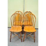 A set of four Oak Windsor style kitchen chairs with X stretchers