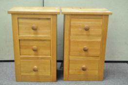 A pair of oak bedside chests of three drawers,