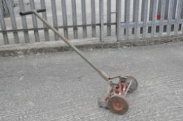 A vintage lawn mower by qualcast