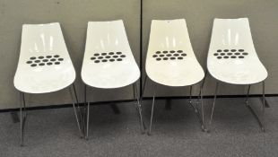 A set of four contemporary Calligaris Jam Jar white plastic chairs, raised on steel wire legs,