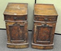 A pair of Victorian walnut bedside cabinets, each curved fronted example carved with fan ornament,