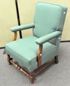 A green upholstered armchair,
