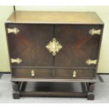 An Oriental style cocktail cabinet, the two cupboard doors opening to reveal two tiers,