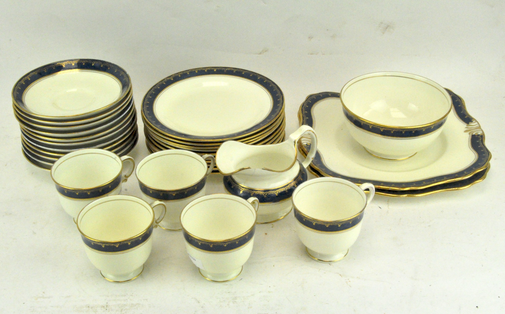 A Tuscan china "Plant" pattern part tea service with blue border, reg no 771590, including tea cups,