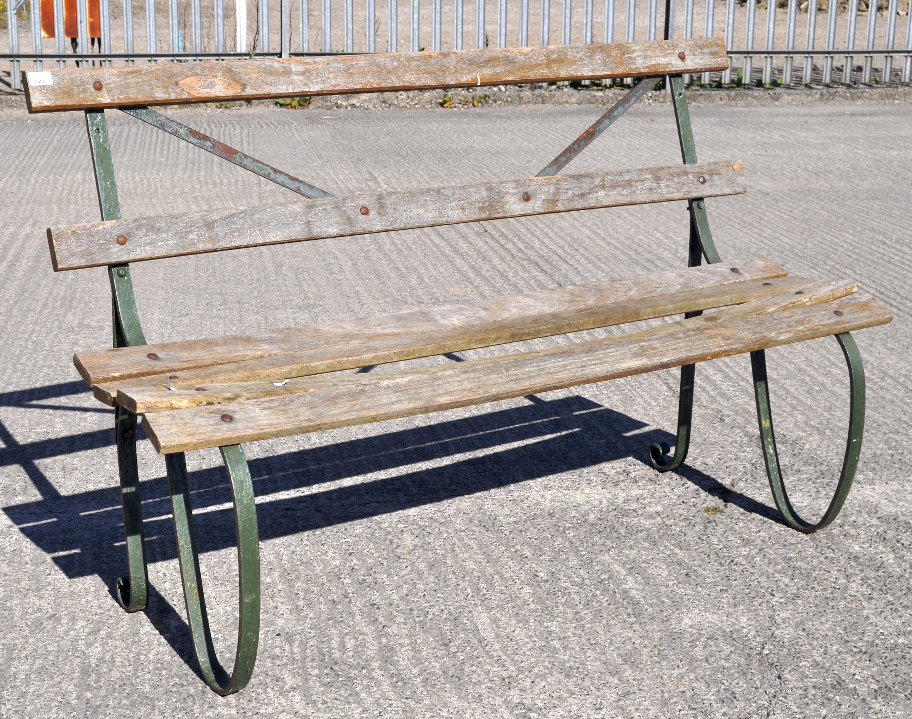 A late 19th century/early 20th century wrought iron bench,