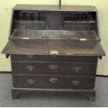 A 19th century oak bureau with carved decoration throughout,