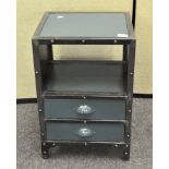 A vintage industrial style metal two drawer bedside cupboard, each drawer with shell shaped handles,