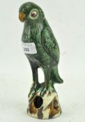 A 19th century Chinese glazed pottery figure of a Sancai parrot,
