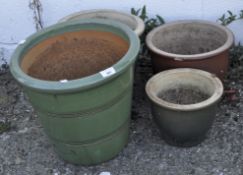 A group of four various glazed plant pots,