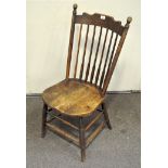 A late 19th/early 20th century Arts and Crafts style Oak stick back chair,