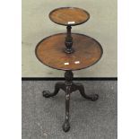 A reproduction George III mahogany two tier dumb waiter, on claw and ball feet,