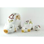 Three ceramic piggy banks,